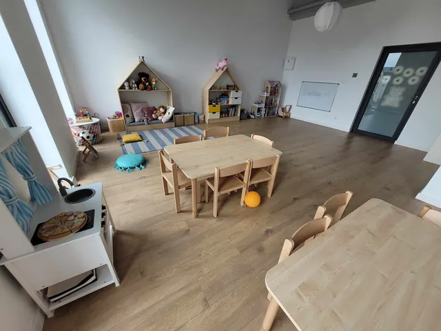 Sala z kącikiem zabaw, kuchenką i stolikami